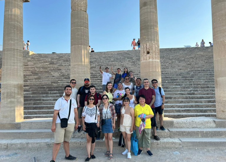 Some of the 2024 Cohort of the Rhodes Academy at the Acropolis in Lindos, Greece.